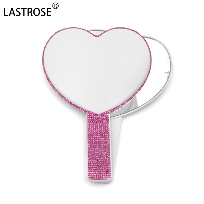 Miroir en forme de cœur blanc avec diamant rose vif