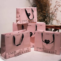 Sacs shopping en papier rose de luxe avec logo personnalisé et poignées en ruban, emballages cadeaux haut de gamme pour boutiques, vente en gros