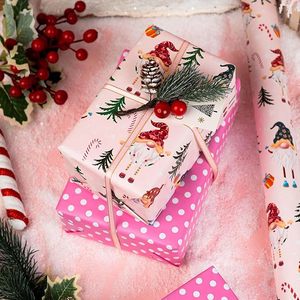 Papel de regalo de Navidad de doble cara rosa con diseño de gnomos de patas largas, bastones navideños y caramelos, en papel estampado. - Product Image 1