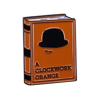 Sebuah Pin Enamel Buku Oranye Mesin Jam Menunjukkan Cinta Anda untuk Sastra Yang Bagus dan Budaya Konter!