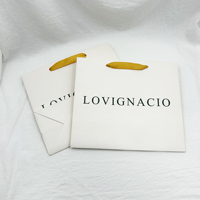 Bolsa de papel de compras reutilizable con impresión de logotipo personalizado de marca de lujo reciclable con asa de cinta