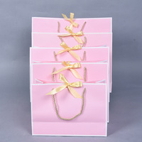 Sac en papier rose personnalisé de luxe pour vêtements, cadeaux et bijoux