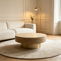 Table basse moderne en bois avec piétement doré champagne, plateau texturé aspect pierre, table centrale circulaire pour salon