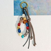 Porte-clés vintage bohème 2026 avec pendentif à pompon, perles et macramé fait main en plastique tressé, pour sac