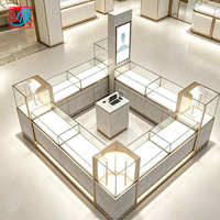 Meubles de magasin de bijoux de luxe haut de gamme, marbre et cadre doré, éclairage LED, comptoir d'exposition de bijoux en verre, armoire de réception