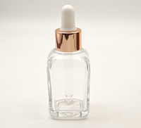 Flacon compte-gouttes carré en verre ambré vide de 10 ml avec anneau doré et bulbe en caoutchouc noir, pour huiles essentielles et cosmétiques, opaque, vente en gros