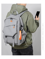 Sac à dos scolaire unisexe gris élégant et imperméable avec logo personnalisé, fermeture éclair, protection antichoc pour ordinateur portable, port USB, capacité 36-55L