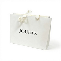 Sacs en papier blancs de qualité supérieure avec logo personnalisé, poignée en corde de coton, logo imprimé UV noir pour l'emballage de vêtements et de bougies