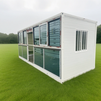 Maison conteneur préfabriquée modulaire en acier de 20 pieds avec mur rideau en verre pour bureau, studio, jardin, extérieur