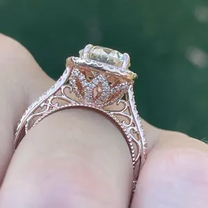 moissanite Ring set in 14k AU585 rose gold in a Halo inspired intricate filigree setting with moissanite diamond accents