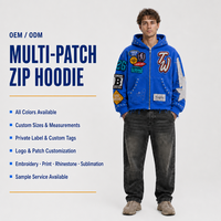 Sweat à capuche zippé surdimensionné en coton French Terry personnalisé, avec broderies multi-appliques cloutées, effet délavé vintage, style streetwear pour homme
