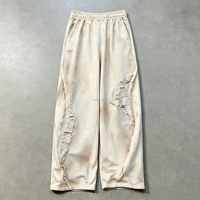 Pantalon de survêtement vintage délavé et déchiré pour homme, coupe large, taille élastique, avec bords bruts et patchwork, style streetwear