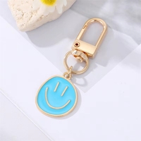 Porte-clés mignon en alliage de zinc jaune bleu noir émaillé avec visage souriant pour femmes