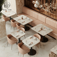 Ensemble de mobilier pour café et restaurant : table en marbre et chaises en cuir, banquette en velours rose à surpiqûres verticales