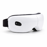 Masque de massage oculaire avec compression d'air, compresse chaude, vibration et musique, appareil de soin des yeux rechargeable blanc