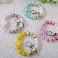 Niedliches Blumen-Silikon-Perlenarmband mit Blumendruck, elastisches Schlüsselband, Handtaschenanhänger, Damen-Taschenaccessoire