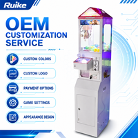 Máquina recreativa de grúa de garras pequeña de metal y plástico Ruike con interfaz en inglés, Mega Mini, operada con monedas, para premios de peluche