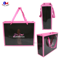 Sac en papier noir réutilisable de luxe avec poignée pour emballage de vêtements, cadeaux et achats professionnels, personnalisable et durable