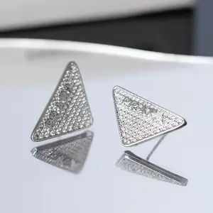 Triangle label earrings