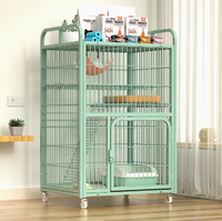 Cage à chat multi-niveaux en métal vert avec roulettes et espace de rangement, villa intérieure pour chats