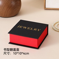 Boîte à bijoux en forme de livre à couvercle noir avec feuille d'or, plateau intérieur et emballage d'accessoires de type tiroir