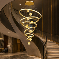 Lustre en cristal spirale multi-anneaux doré de luxe pour hall d'hôtel, design personnalisé avec cadre métallique rond, lampe suspendue pour villa