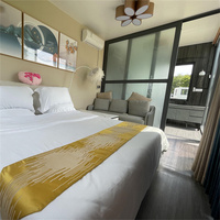 Maison Capsule Préfabriquée de Luxe en Acier Moderne de 20/40 pieds, 2 Chambres, Style Apple, avec Panneaux Solaires et Espace Multifonctionnel