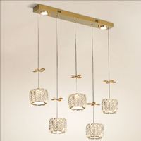 Lustre suspendu moderne de luxe en acier inoxydable avec plusieurs têtes cylindriques, fleurs en cristal doré, pour bar et salle à manger