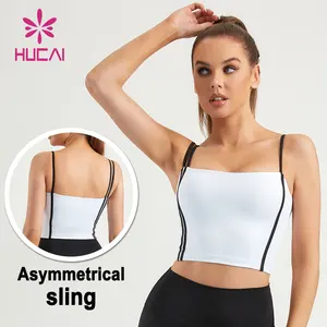 HUCAI OEM poliéster Spandex tira de empalme slim fit mujeres asimétrico Sling entrenamiento gimnasio yoga deportes crop Tank Top sujetador acolchado