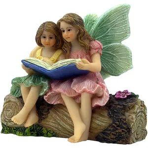 仙女小雕像2个可爱的仙女坐在树桩上看书