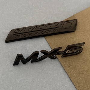 Emblema con Logotipo <span class=keywords><strong>R</strong></span> en Negro Brillante Estilo KZ para <span class=keywords><strong>Mazda</strong></span> Miata MX-5 <span class=keywords><strong>MX5</strong></span> NA NB NC ND, Adhesivo con Letras para Maletero Trasero SKYACTIVD - Product Image 1