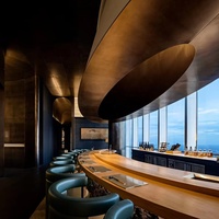 Ensemble de bar moderne de luxe avec tabourets en cuir vert et comptoir en bois massif incurvé pour utilisation en restaurant