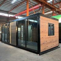 Casa Container Espandibile con Telaio Nero e Layout Interno Personalizzabile, Adatta per Vivere in Singolarità o in Comunità