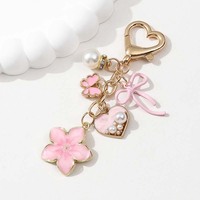 Porte-clés en métal pour femme, motif fleurs colorées et nœuds, avec perles et papillons, tendance et personnalisé, vente en gros