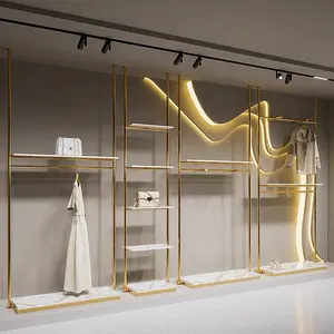 Magasin de vêtements de luxe présentoir en métal doré vêtements vêtements étagères en acier inoxydable mural vêtements suspendus support