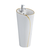 Ensemble WC monobloc avec lavabo sur colonne, design blanc et lignes dorées