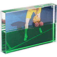 Cadre photo liquide en acrylique avec flotteurs de ballons de football et de coupes dans un fond de gazon, paillettes dans le cristal haute clarté, OEM