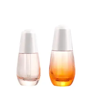 Cosmétique de luxe de 30ml 50ml sérum d'huile vide transparent clair flacons compte-gouttes or bouton poussoir flacon compte-gouttes en verre dépoli