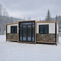 Maison modulaire préfabriquée moderne, maison préfabriquée à ossature en acier noir, maison en kit, bande lumineuse LED, mur en placage de pierre, cour arrière