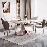 Table à manger ronde design avec un plateau en pierre durable et une base en acier finition or rose électrolytique pour meubles de maison modernes