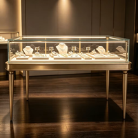 Vitrine de présentation de bijoux en métal doré antique avec pieds, comptoir en verre éclairé pour boutique de joaillerie haut de gamme