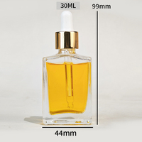 Botol tetes Serum minyak esensial kaca bening persegi datar 30ml 50ml dengan kepala emas dan kotak kemasan kustom