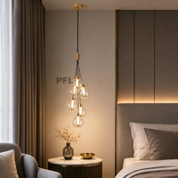 Suspension LED contemporaine verticale élégante en cascade, en fer doré de luxe et verre transparent, longue, pour éclairage d'ambiance