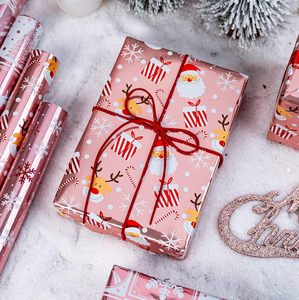 Papel de Regalo Navideño con Diseño de Copos de Nieve Rosas, Árboles de Navidad, Campanas, Dulces y Estrellas - Product Image 1