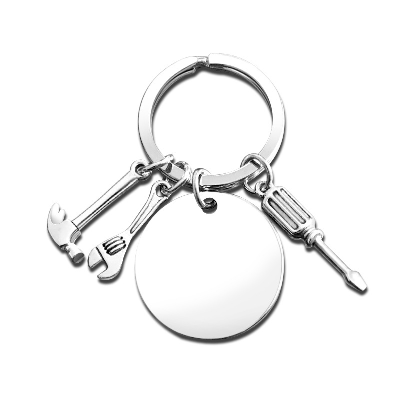 Porte-clés argenté 30 mm rond, clé à molette, tournevis, marteau argenté.