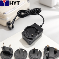 Adaptateur de voyage universel portable HYT AC DC 100-240V Entrée 24V 12V 1A 2A Prise interchangeable UK US EU AU