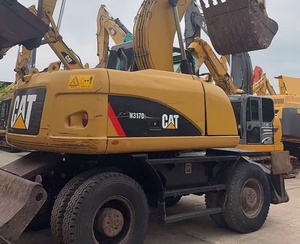 Excavatrice sur pneus CAT M317D2 <span class=keywords><strong>d</strong></span>'occasion à faible nombre <span class=keywords><strong>d</strong></span>'heures de fonctionnement avec dozer frontal, stabilisateurs arrière et ligne de brise-roche préinstallée pour l'asphalte - Product Image 4