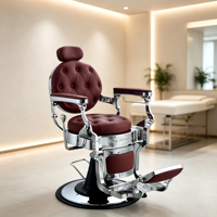 Chaise de barbier de style rétro, capitonnée ronde, base chromée brillante et détails métalliques ornés.