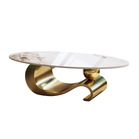 Table basse ovale en pierre frittée, base contemporaine en acier inoxydable doré, pièce maîtresse moderne pour salon