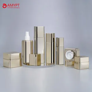 Bottiglie quadrate in oro brillante e confezioni cosmetiche di vasetti vuoti